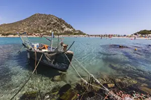 Rope Prints: A fishing boat in the turquoise sea surrounding the sandy beach