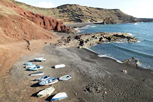 Azure Water Prints: Fishing boats black sand beach