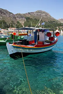 Navigation Prints: Fishing boats docked in clear waters of Megisti Bay, Kastellorizo, Greece under bright sun