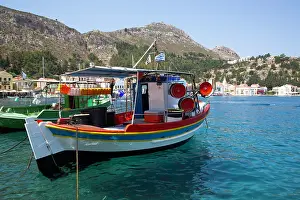 Fishermen Prints: Fishing boats docked in Megisti Bay with clear blue water and surrounding hills in Kastellorizo