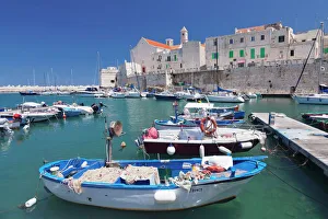 Pier Gallery: Fishing boats at the harbour, old town with cathedral, Giovinazzo, Bari district