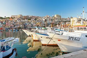 Sicily Prints: Fishing boats moored in the harbour surrounded by blue sea and the old town, Sciacca