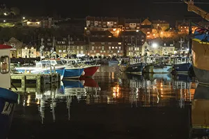 Whitby Prints: Fishing boats moored in Whitby harbour at night, Whitby, North Yorkshire, England