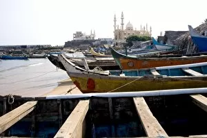 Fishing boats with a mosque in the background, Vizhinjam, Trivandrum, Kerala, India, Asia