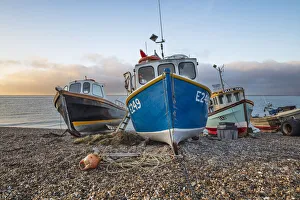 Nautical Vessel Prints: Fishing boats pulled up on shingle beach at sunrise, Beer, Jurassic Coast, Devon, England