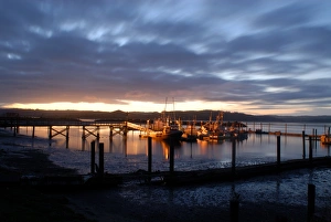 Motionless Prints: Fishing and crabbing boats at low tide after sunset