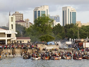 Crowded Prints: Fishing market with modern city behind, Dar es Salaam, Tanzania, East Africa, Africa