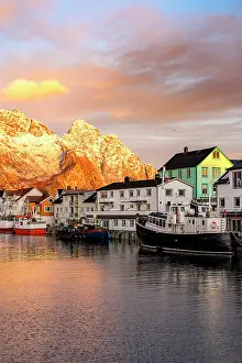 Small Prints: Fishing village at autumn sunset with mountains in background and reflections in water in Lofoten Islands