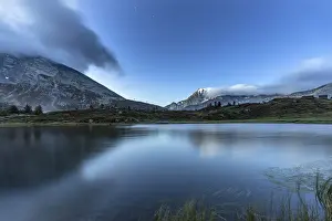 Mountain Pass Prints: Fletschhorn mountain peak reflected in the pristine water of Hopschusee lake at dusk