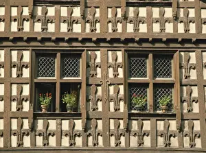 Timber Prints: Detail of fleur-de-lys motif carved in wood on the timber framed Market Hall in the village of Arreau