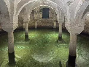 Underground Prints: Flooded area in the crypt of Basilica of San Francesco in Ravenna shows historical architecture and water effects