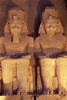 Nubian Prints: Floodlit colossi of Ramses II (Ramesses the Great), seated statues on facade of temple
