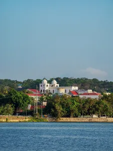 Flores Prints: Flores Island stands with white buildings under a clear sky seen from Santa Elena in Guatemala