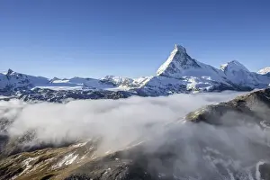 Fog revealing the mountain range surrounding the massif of the Matterhorn, Swiss Canton of Valais, Swiss Alps, Switzerland, Europe