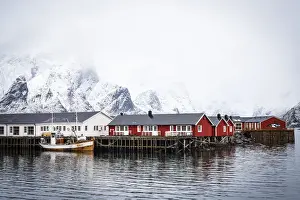 Hamnoy Prints: Foggy sky over snowcapped mountains and traditional Rorbu cabins by the sea