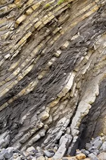 Folded layers of Jurassic sedimentary limestone and marl rocks in the cliffs at Vega beach, Ribadesella, Asturias
