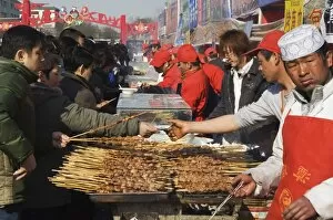 Food s talls s elling meat s ticks at Changdian s treet Fair during Chines e New Year