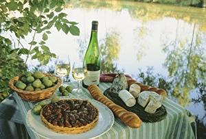 Glass Prints: Food and wine on a table beside the river Loire, France, Europe
