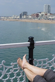 Legs Prints: Foot sunbathing on the pier, Brighton, Sussex, England, United Kingdom, Europe