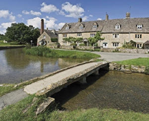 Footbridge over River Eye, Lower Slaughter village, the Cotswolds, Gloucestershire