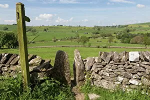 Wooden Post Gallery: Footpath sign and stone stile with dry stone wall, near Alstonefield, Peak District National Park