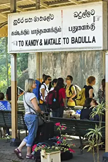 Kandy Prints: Foreign travellers await the popular Colombo to Badulla train at the railway station at Peradeniya