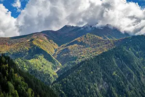 Season Prints: Forested mountains rise in the Caucasus region surrounded by clouds in South Ossetia
