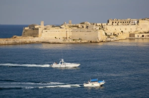 Water Taxi Prints: Fort Ricasoli from Valletta, with yacht and water taxi passing, Malta, Mediterranean