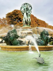 Bronze Prints: Fountain of the Four Parts of the World shows water spraying over statues in fall season in Paris