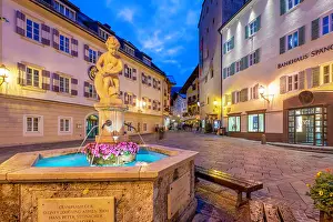 Enjoyment Prints: Fountain in Stadtplatz at dusk with buildings and lights in Zell am See, Salzburg, Austria
