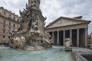 The fountain with statues frames the ancient temple of Pantheon, UNESCO World Heritage Site