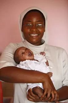 Images Dated 8th June 2009: Franciscan sister holding an orphan at nursery and kindergarten run by Catholic nuns
