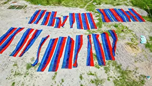 Skills Prints: Freshly dyed cloths laid out for drying in Araihazar village