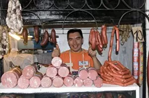 Friendly man selling sausages and meat, Khojand, Tajikistan, Central Asia, Asia