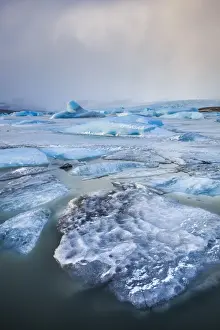 Blue Ice Prints: Frozen icebergs locked in the frozen waters of Fjallsarlon Glacier lagoon