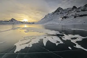 Lago Bianco Prints: The frozen surface of Lago Bianco framed by snowy peaks at dawn