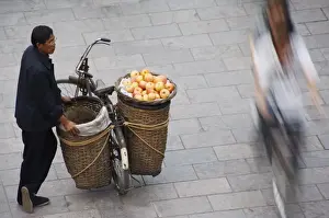 Street Vendor Prints: A fruit seller watching people pass by in the historic old town of Pingyao City