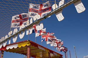 Nationalism Prints: Funfair flags on beach, Selsey Bill, Sussex, England, United Kingdom, Europe