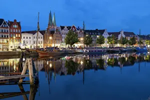 Mirror Prints: Gabled houses and boats reflected in the canal at night in Lubeck