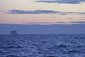 Lancashire Prints: Gas platform silhouetted on horizon at dusk, Morecambe Bay Gas Field, Lancashire