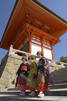 Japanese Ethnicity Prints: Three geishas in traditional dress walking down steps