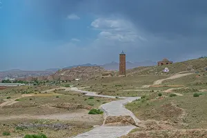 Minarets Prints: Ghazni Minarets stand in an ancient landscape with paths leading through dry terrain during cloudy weather