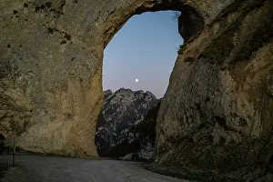 Terrain Prints: Giant arch frames mountain view with moonrise in Chechnya, Caucasus region of Russia