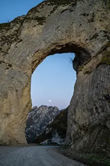 Large Prints: Giant arch in mountain landscape with moon view during twilight in Chechnya
