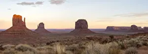 Alpen Glow Prints: The giant sandstone buttes glowing pink at sunset in Monument Valley Navajo Tribal