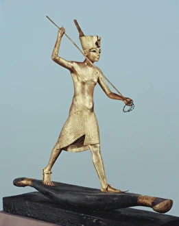 Pharaoh Prints: Gilt wood statuette of Tutankhamun on a boat with a harpoon