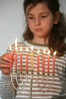Images Dated 28th March 2007: Girl lighting Hannuka candles, Montrouge, France, Europe