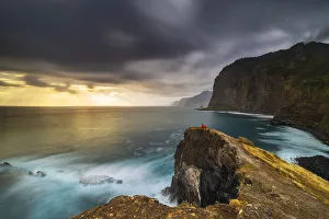 Kids Prints: A girl looking at the sea during sunrise from cliffs of Guindaste