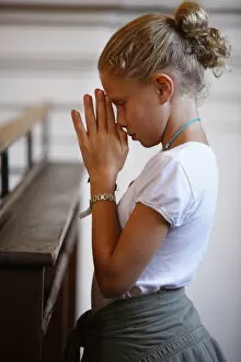 Images Dated 21st August 2008: Girl praying in church, Saint Nicolas de Veroce, Haute Savoie, France, Europe