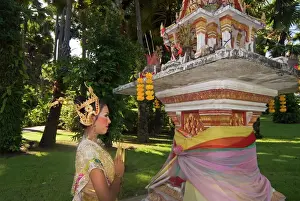 Thai Culture Prints: Girl in traditional Thai clothes praying at a spirit house